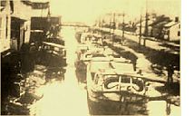 Line boats moored in the canal.